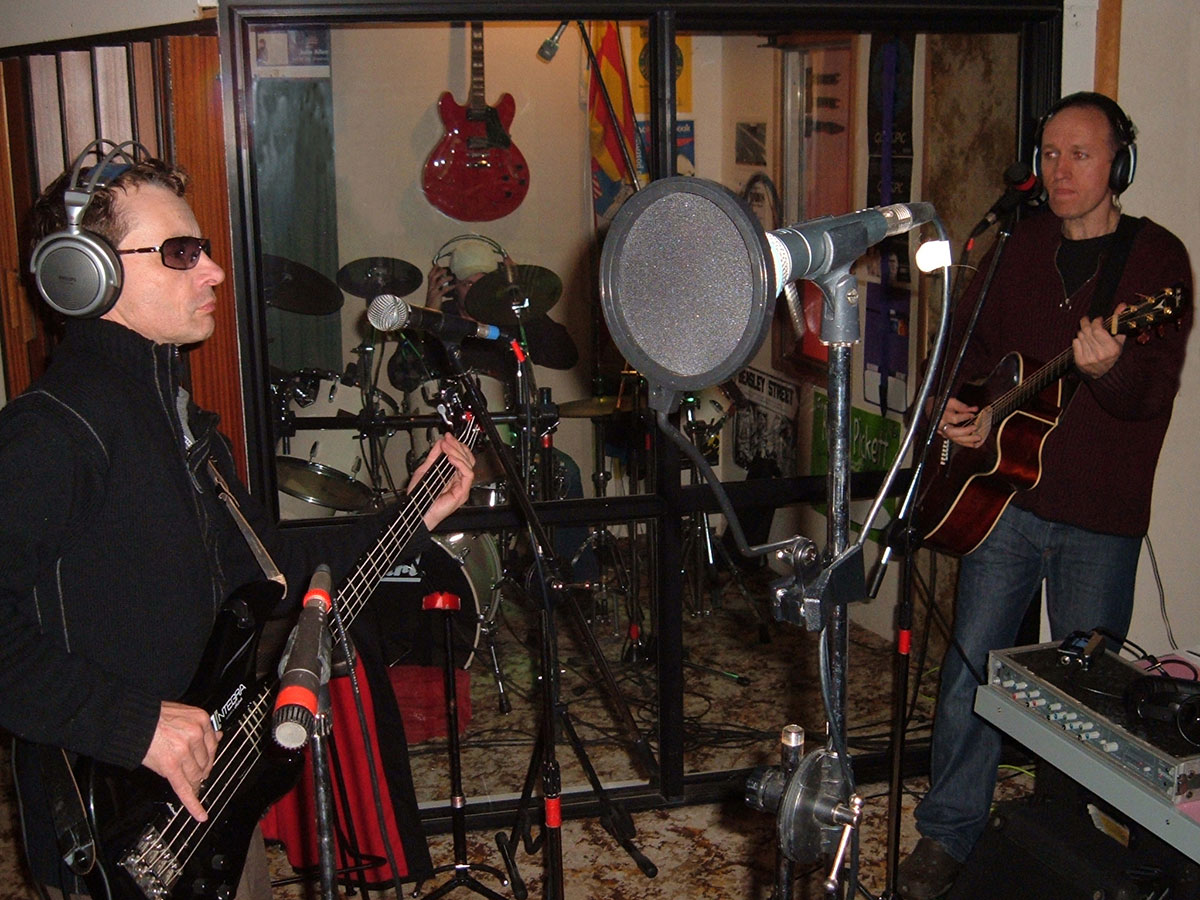 IMAGE: The Boatshed, September 2006. From the POV of the singer: Howard, Chris (obscured) and Simon recording Fractured for the Live Again album.